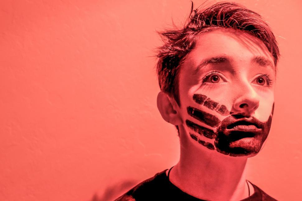Free Image of Young boy in red light 