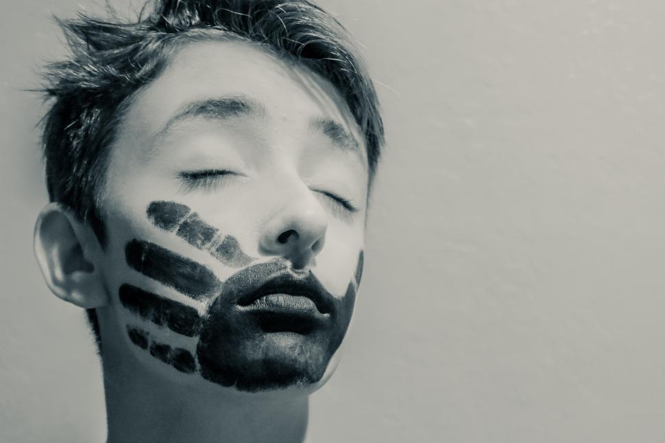 Free Image of Boy with eyes closed and handprint mouth 