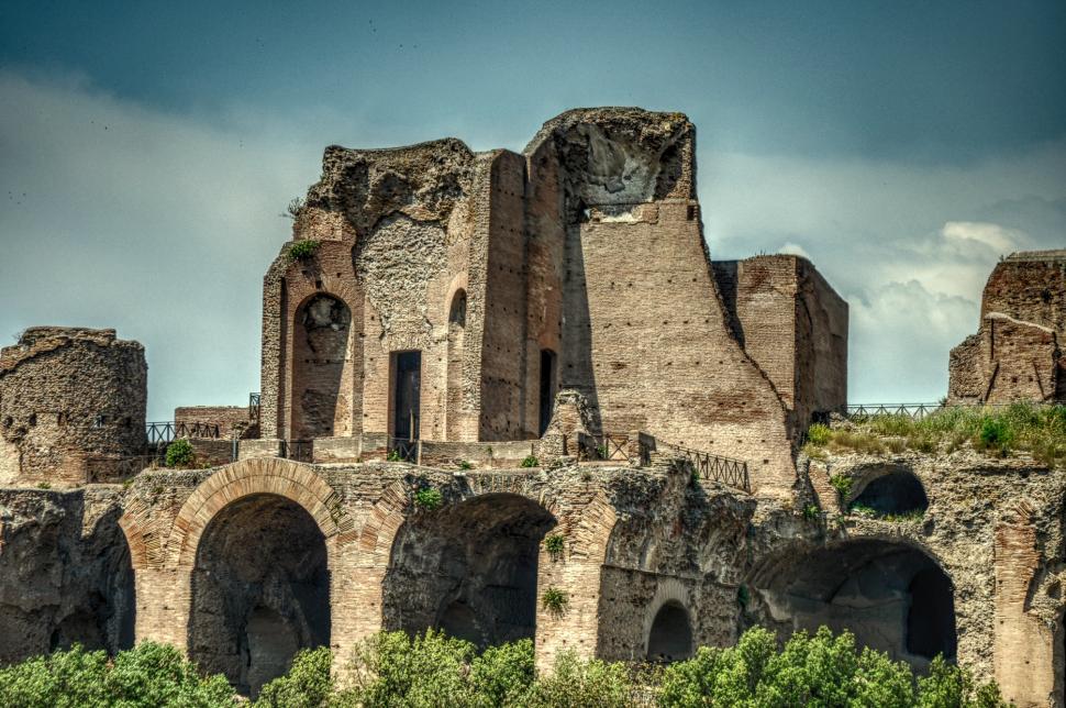 Free Image of The Ruins of a Large Building Against a Sky Background 