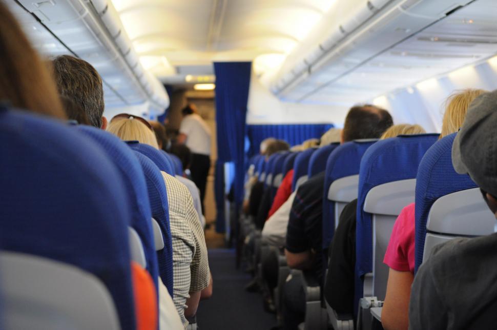 Free Image of Group of People Sitting on an Airplane 