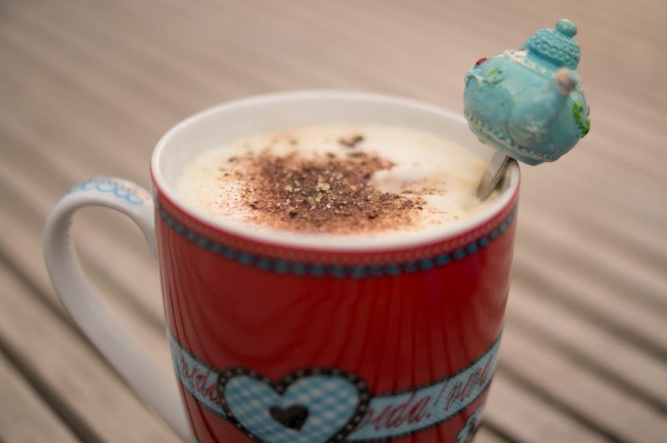 Free Image of A Cup of Coffee With a Bird Perched on Top 