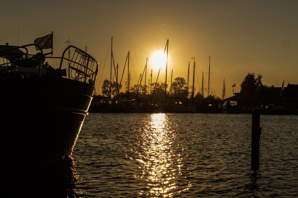 Free Image of Boat Floating in Water at Sunset 