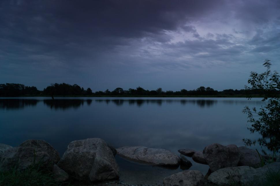Free Image of Rocky Waterfront Under Cloudy Sky 