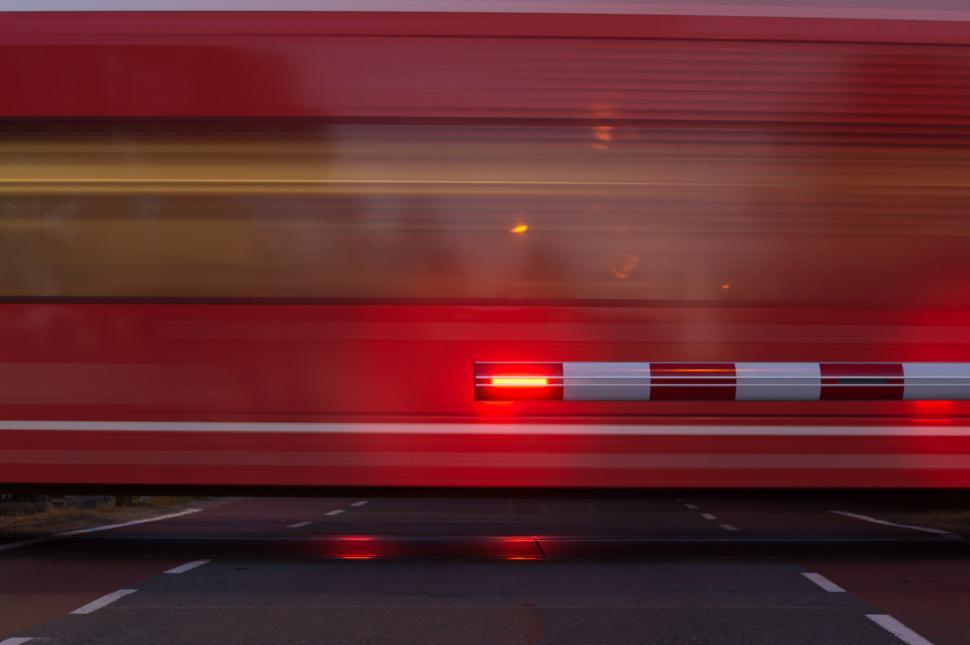 Free Image of Red Train Passing Traffic Light on Train Tracks 