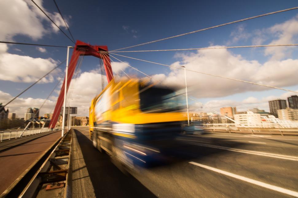 Free Image of Yellow and Blue Bus Crossing Bridge 
