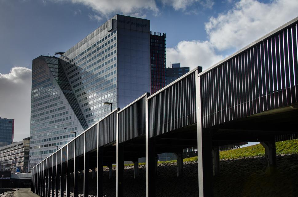 Free Image of Tall Building Next to Bridge 