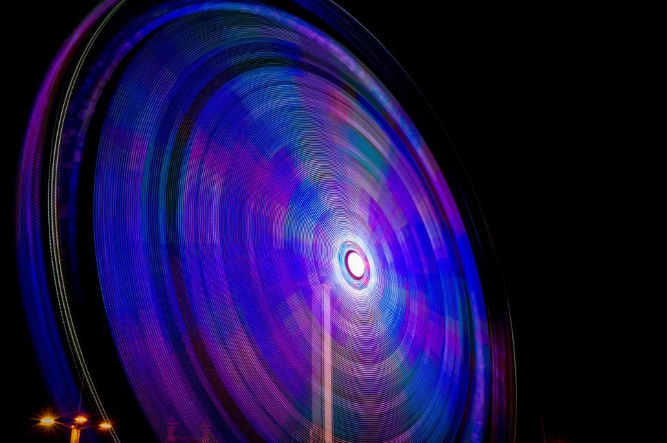 Free Image of Ferris Wheel Illuminated With Blue and Purple Lights 