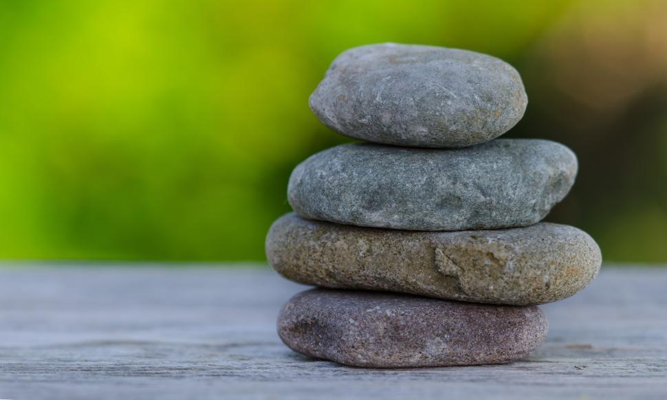 Free Image of Stack of Rocks on Wooden Table 