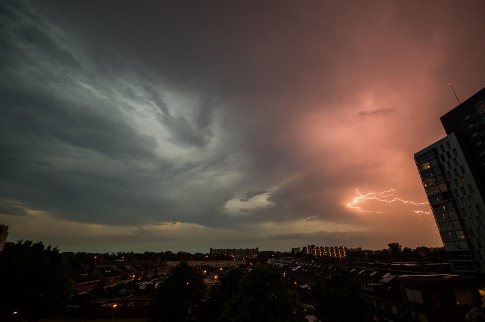 Free Image of Cloudy Sky With Buildings in the Background 
