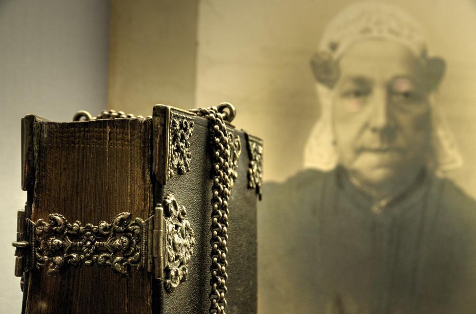 Free Image of Woman Standing Next to a Book 
