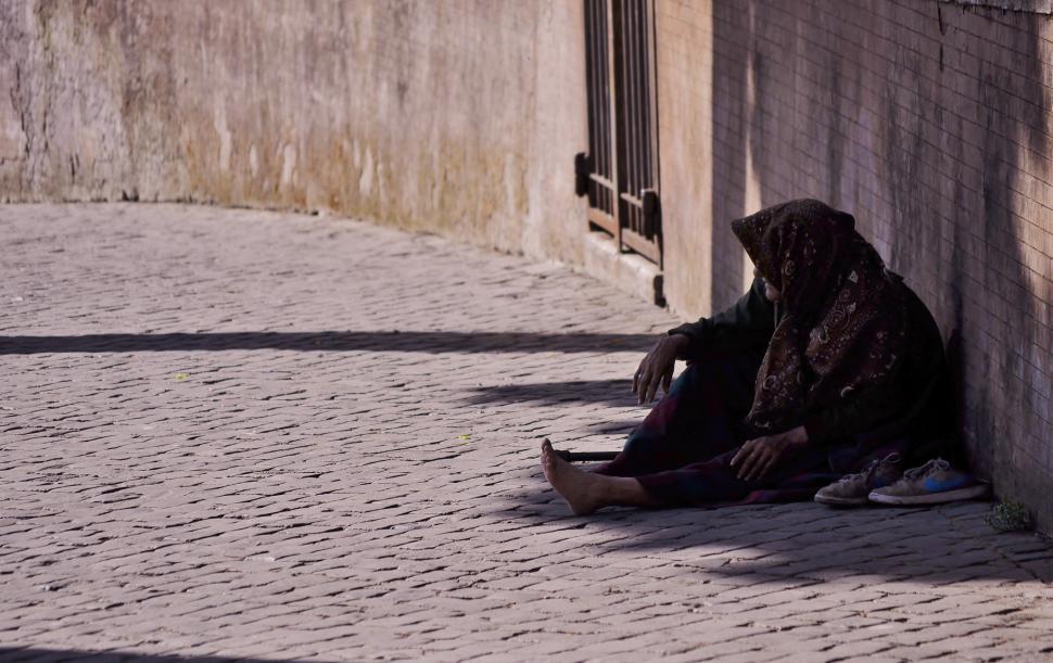 Free Image of Person Sitting Next to Wall 
