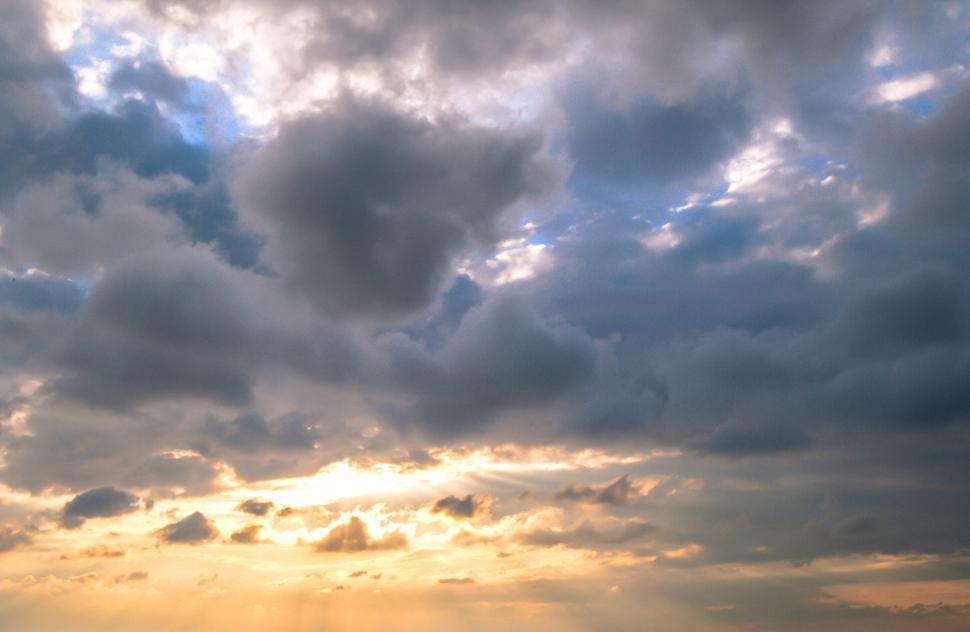 Free Image of Clouds cover the sunset in sky 
