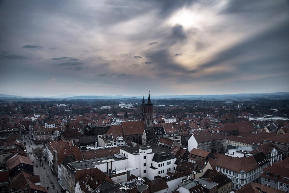 Free Image of Aerial View of City Under Cloudy Sky 