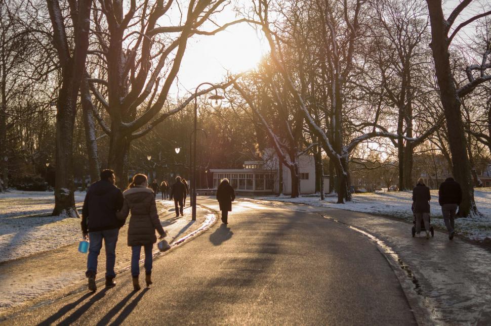 Free Image of Group of People Walking Down Snow Covered Street 