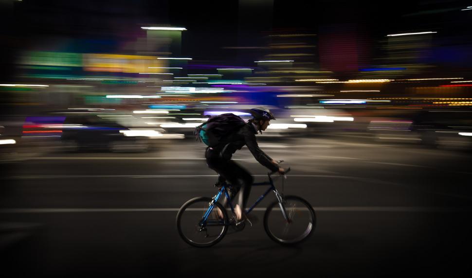 Free Image of Man Riding Bike Down Street at Night 