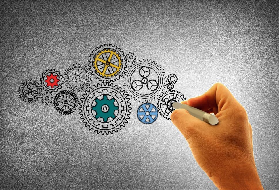 Free Image of Concept of Work - A Person Drawing Cogwheels 