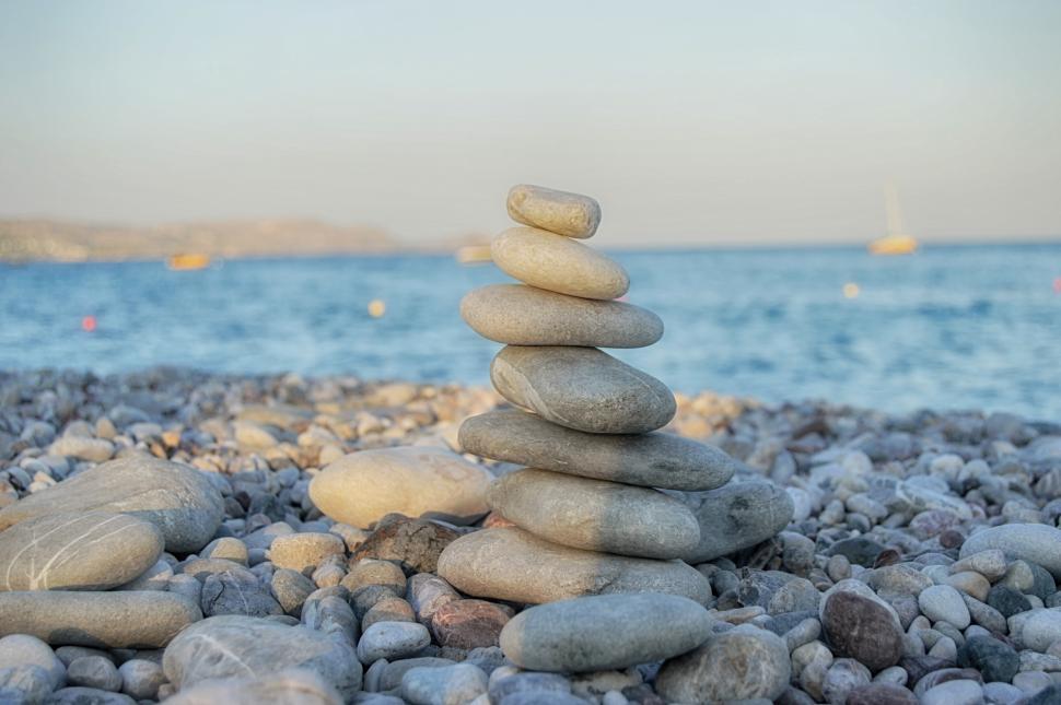 Free Image of Pyramid of stone on the stone beach symbolizing zen  