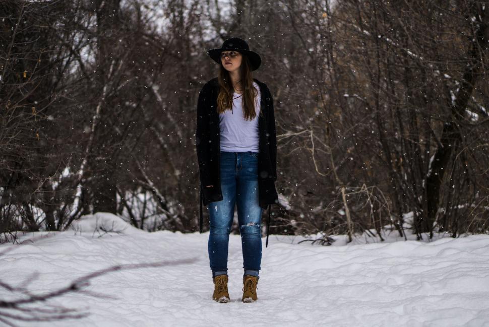 Free Image of A young woman standing in the snow 