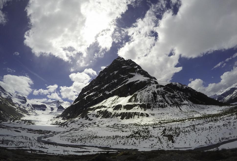 Free Image of Snow Covered Mountain Under Partly Cloudy Sky 
