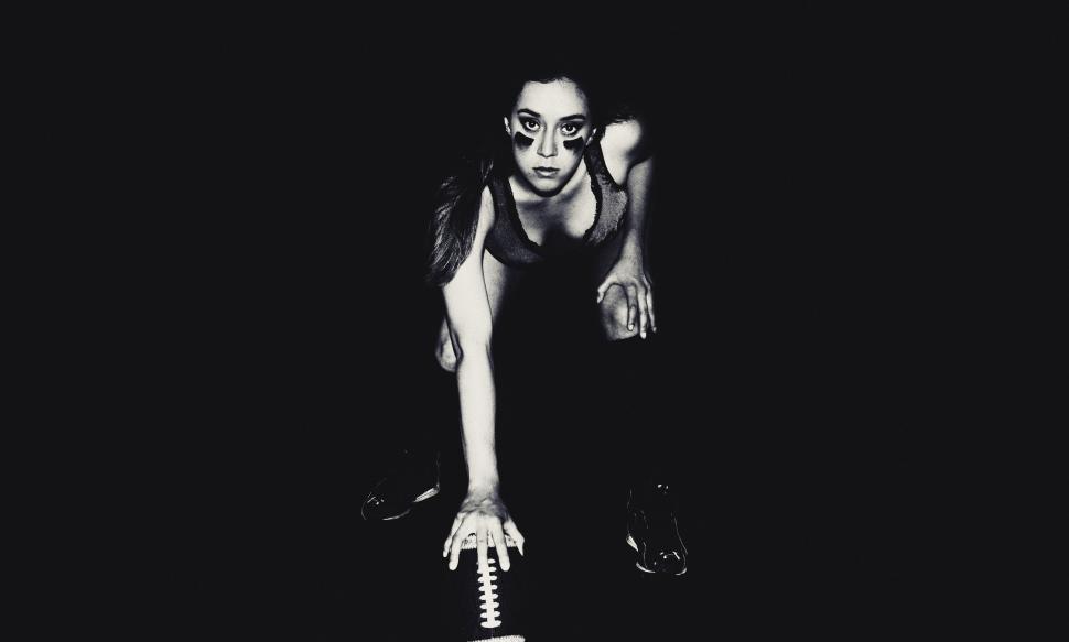 Free Image of Woman Holding Football in Black and White 