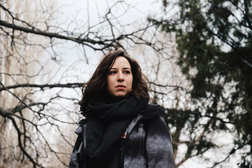 Free Image of Woman Standing in Front of Tree 
