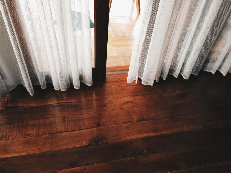 Free Image of Room With Wooden Floor and White Curtains 