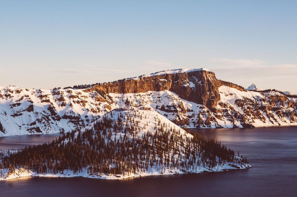 Free Image of Majestic Snow-Covered Mountains Surrounding Large Body of Water 