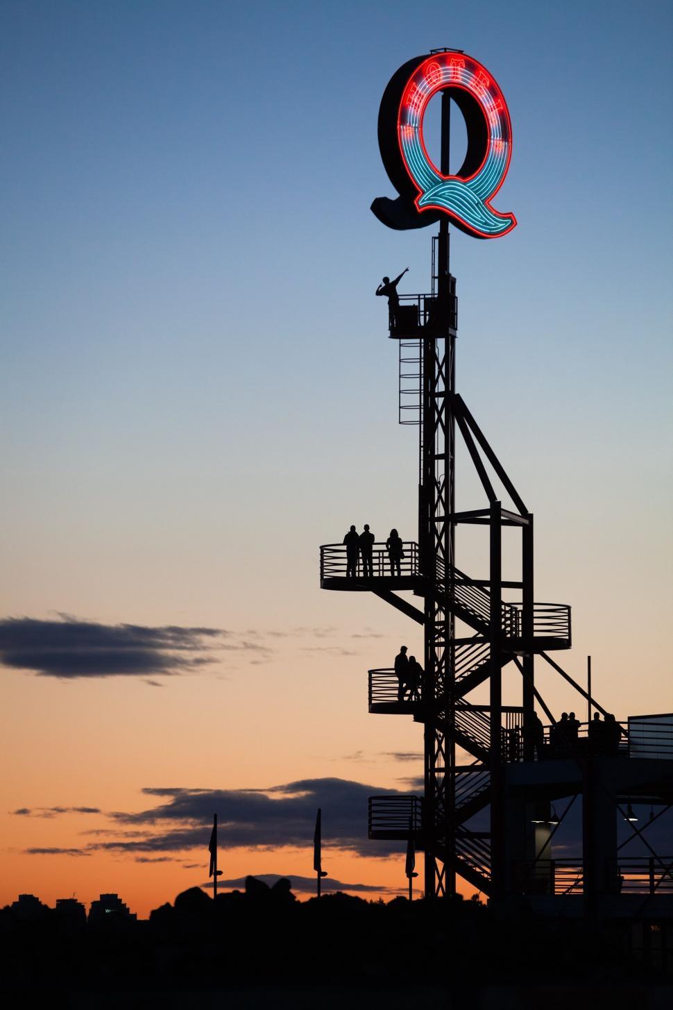 Free Image of Large Sign on Top of Tall Tower 