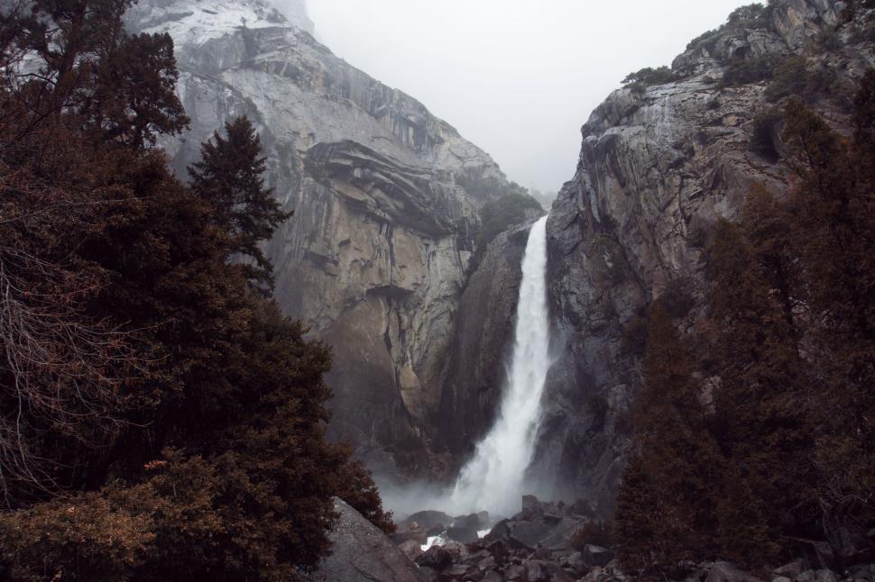 Free Image of Waterfall Cascading in Lush Forest 