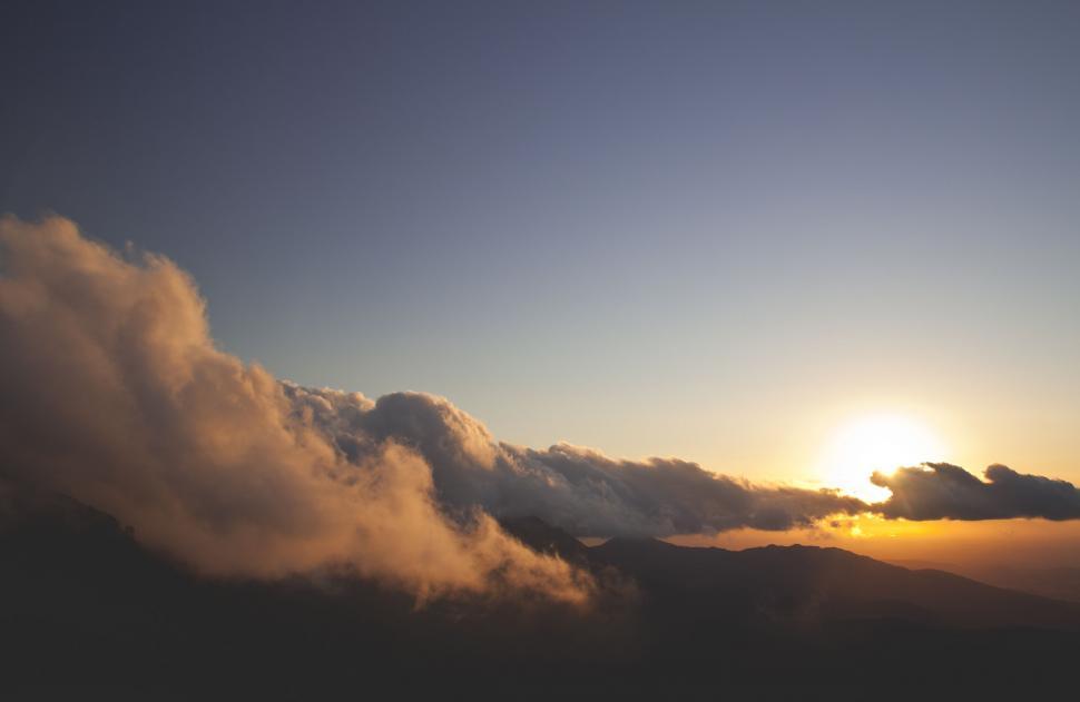 Free Image of Sun Shines Through Clouds in the Sky 