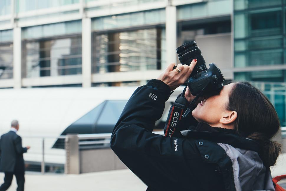 Free Image of Woman Taking a Picture With a Camera 