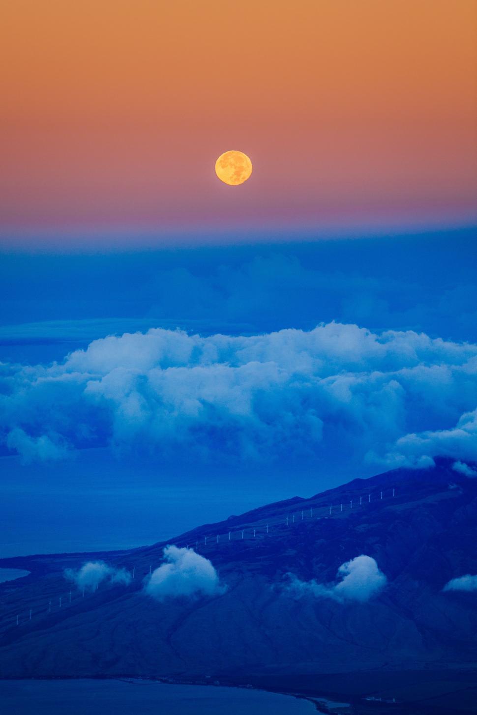 Free Image of Sun Setting Over Clouds in the Sky 