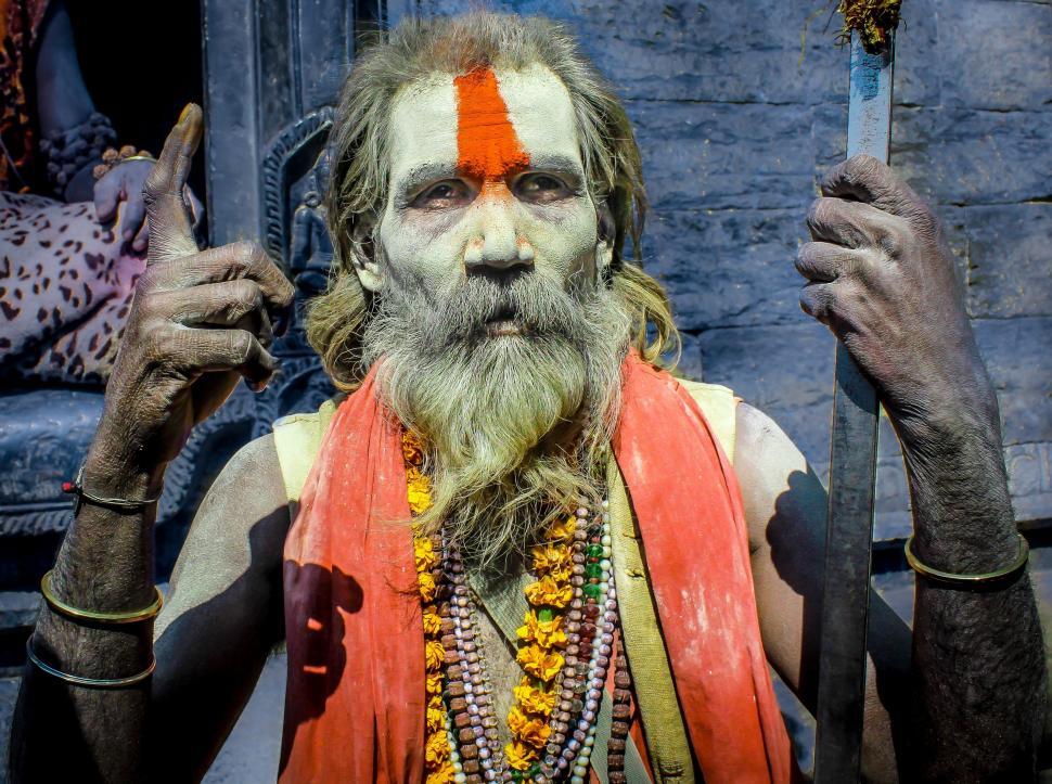 Free Image of Bearded Man With Orange and White Face Paint 