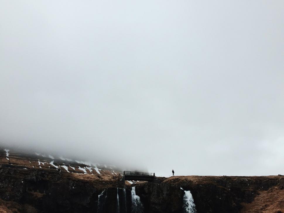 Free Image of Man Flying Kite on Cliff 
