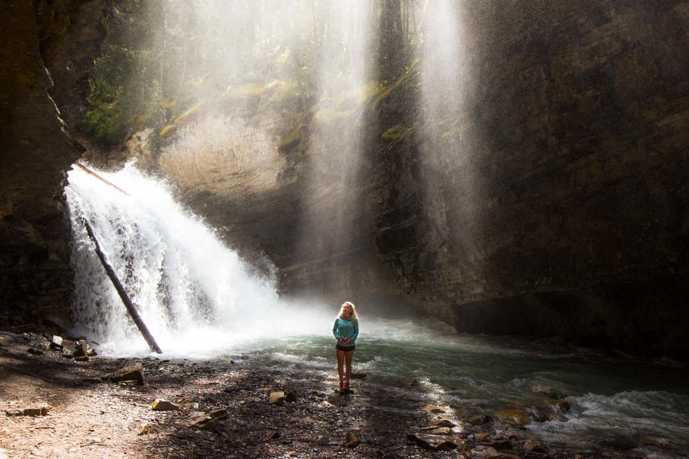 Free Image of Person Standing in Front of Waterfall 