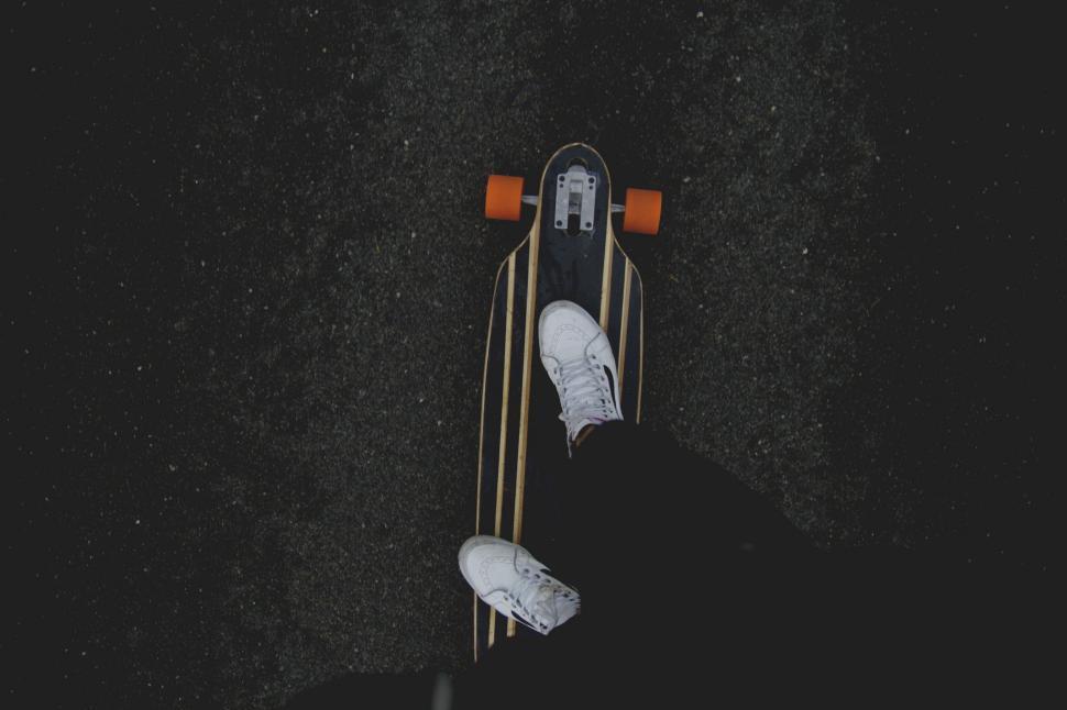 Free Image of Person Standing on Top of Snowboard in the Dark 