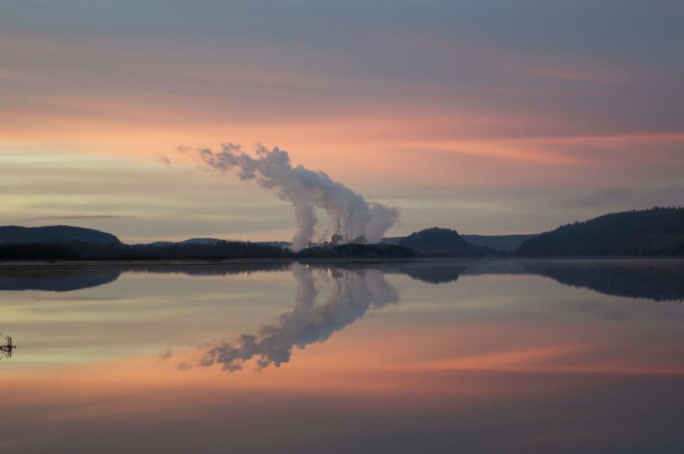 Free Image of Large Body of Water With Plume of Smoke 