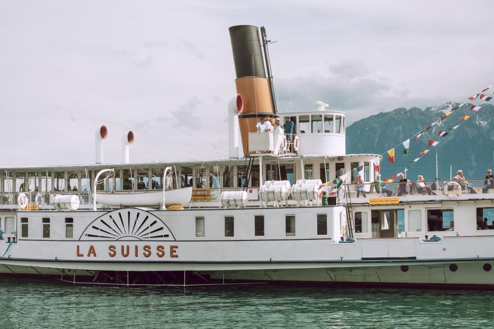 Free Image of Large White Boat Floating on Body of Water 