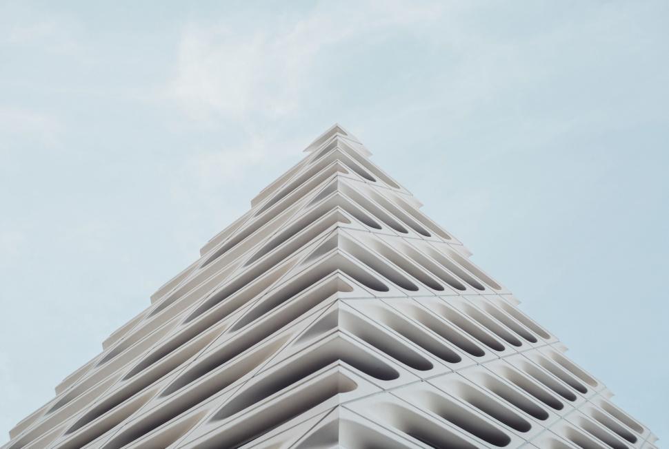 Free Image of Tall White Building Against Sky Background 