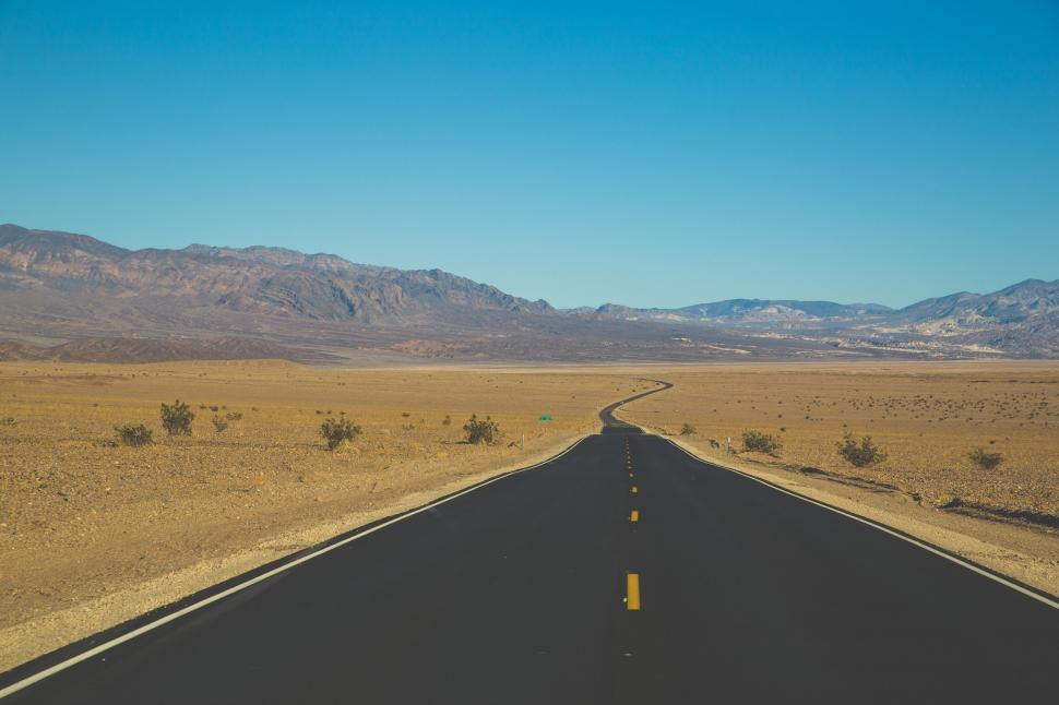 Free Image of Empty Road Cutting Through Desert Landscape 