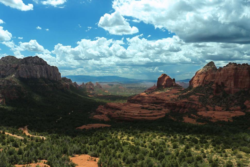 Free Image of Majestic Mountain Landscape With Trees Under Cloudy Sky 