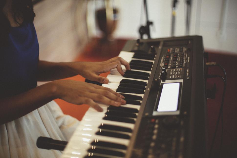 Free Image of Person Playing Keyboard in Front of Microphones 