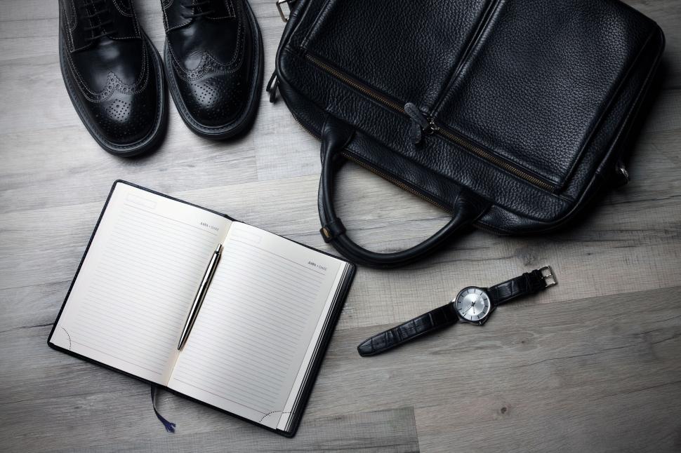 Free Image of Persons Shoes, Notebook, and Pen on Wooden Floor 