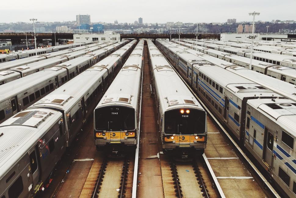 Free Image of Two Trains Parked in Train Yard 