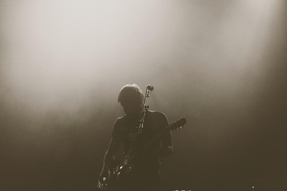 Free Image of Man Playing Guitar in Black and White 