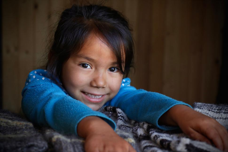Free Image of Little Girl Laying on Top of Bed 