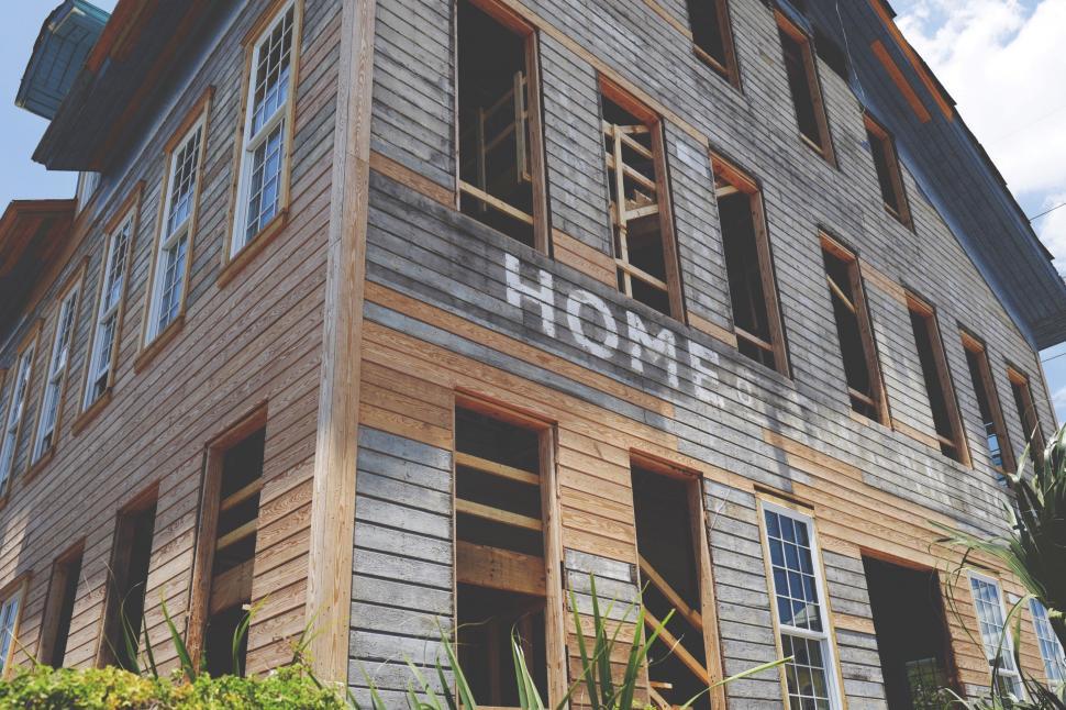 Free Image of Tall Wooden Building With Sign 
