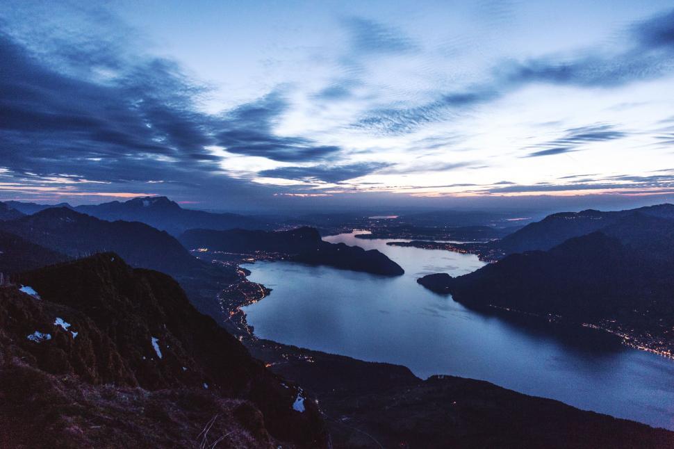 Free Image of Overlooking a Body of Water From a Hill 