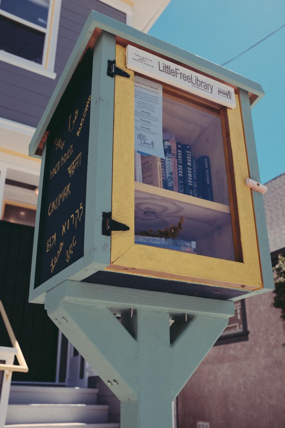 Free Image of Yellow and Blue Mailbox in Front of House 