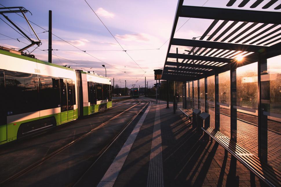 Free Image of Green and White Train Traveling Down Train Tracks 